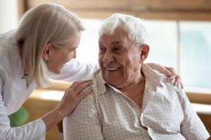 Mature woman caring for her elderly father