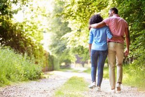 man and woman walking down an outdoor path