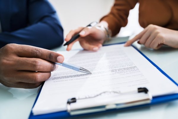 Man and woman reviewing documents on a clipboard