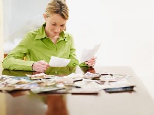 Woman sitting at table selecting photos