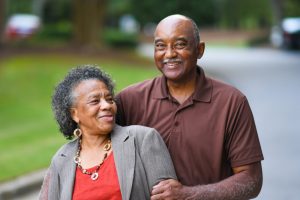 Mature couple walking together, smiling at camera