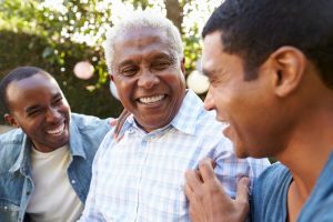 Father with two adult sons laughing and enjoying time together