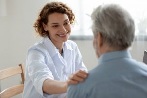 Doctor placing comforting hand on patient's shoulder