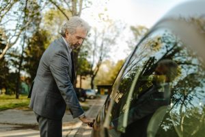 Man in suit opening car door