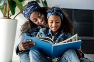 Mom and daughter looking through a photobook as they remember a loved one