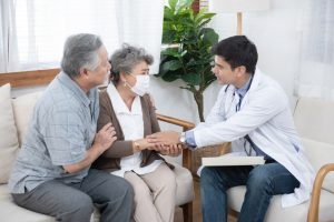 Illustrates doctor talking with older couple about care options