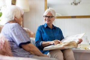 to show a mother and daughter looking at photos and remembering loved ones