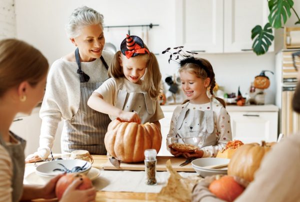 Shows family and grandmother at a Halloween family gathering