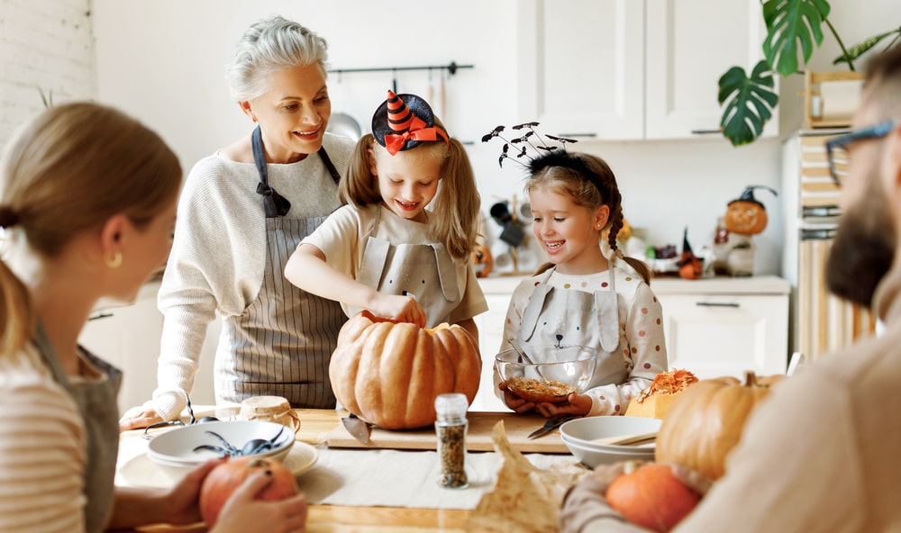 Shows family and grandmother at a Halloween family gathering