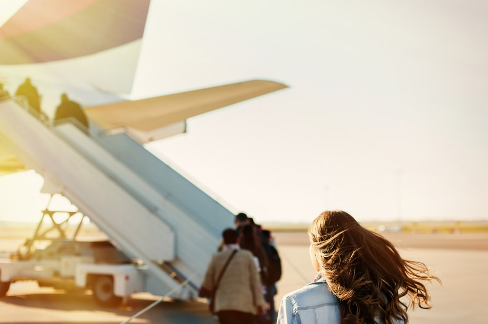 Shows people boarding a plane with sunlight on their hair