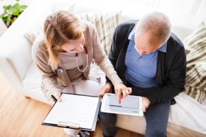 Nurse reviewing paperwork and options with male patient