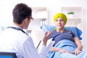 Doctor talking to young patient about treatment options