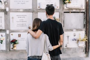 Illustrates why a memorial marker is important as two young people visit a loved one's final resting place