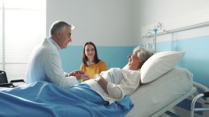 Shows a caring husband and daughter visiting loved one at hospital