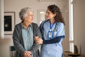 Shows a nurse caring for a female patient during a respite stay