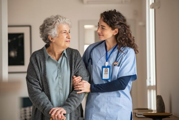 Shows a nurse caring for a female patient during a respite stay