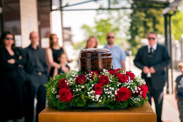 Shows a memorial service with urn
