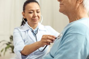 shows female medical professional caring for male patient