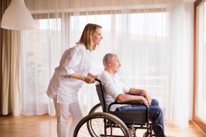 Shows sick man sitting in wheelchair as he benefits from medical care