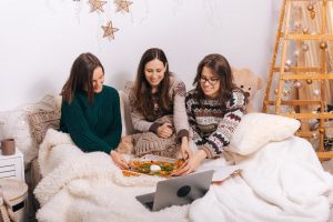 Shows three women eating dinner together and having fun