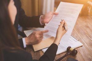 Two people reviewing official documents together