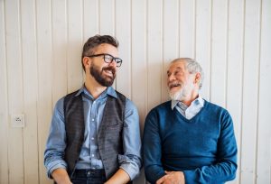 Father with adult son, laughing together