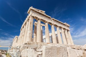 Ruins of an Ancient Greek temple against a blue sky