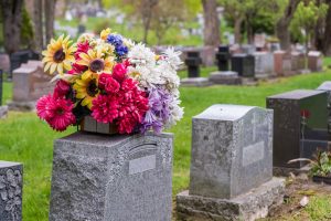 traditional upright headstones with flower arrangements
