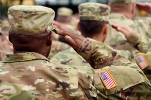 military servicemembers in formation saluting forward