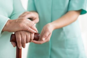 Nurse holding patient's hand in a caring way