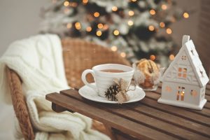 cozy chair next to table with coffee and Christmas decorations