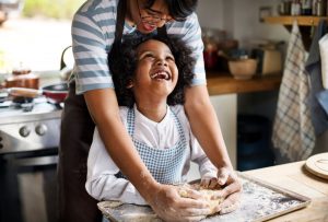 Mother and young daughter baking together, making memories