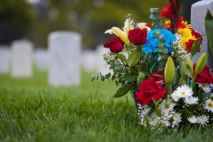 White grave markers and flowers at a national cemetery.