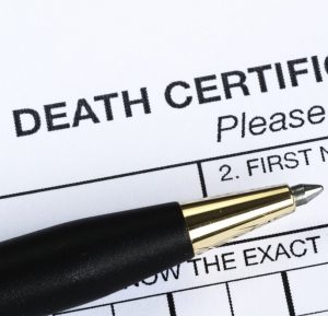 Death certificate request form with pen on top