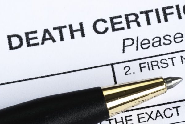 Death certificate request form with pen on top