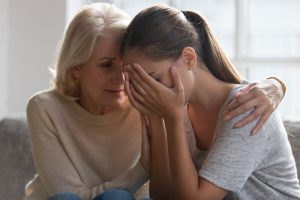 older woman comforting her adult daughter