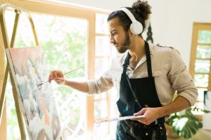 Young man learning to paint, fulfilling a bucket list item