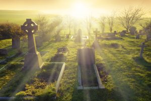grave at Easter with bright sunrise behind