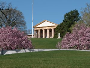 Shows Arlington House high on the hill, surrounded by blossoming trees and green grass