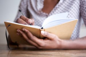 woman writing in a grief journal