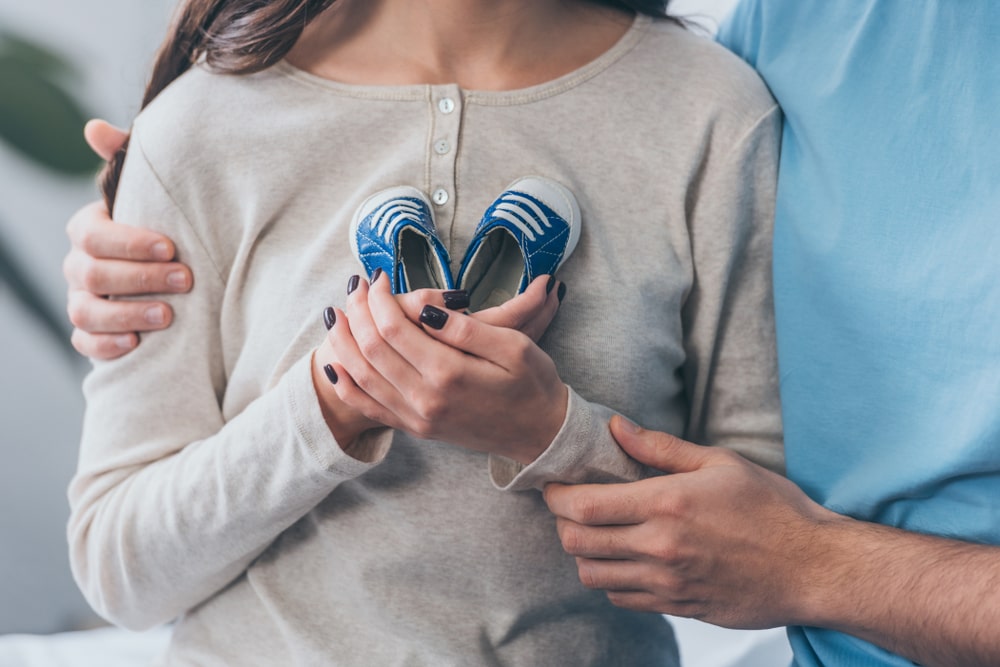 woman holding child's shoes after losing a child