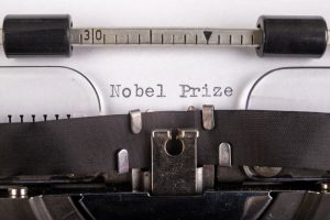 typewriter with typed paper in it that says Nobel Prize