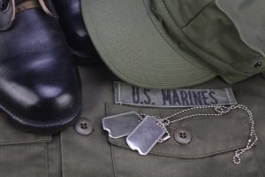 Shows Marine uniform, dog tags, and boot