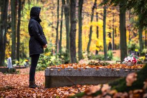 Person standing in front of a grave