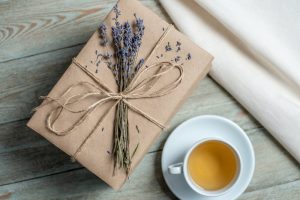 book wrapped in brown paper with lavender tied to it