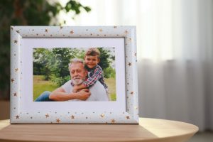 picture of grandfather and grandson in a photo frame covered in gold stars