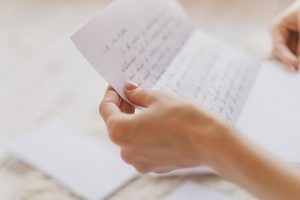 Person holding a handwritten letter