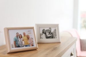two family photos on a shelf