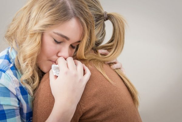 mother comforting her teen daughter