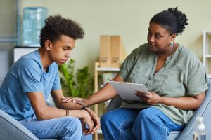 counselor helping a teenage boy